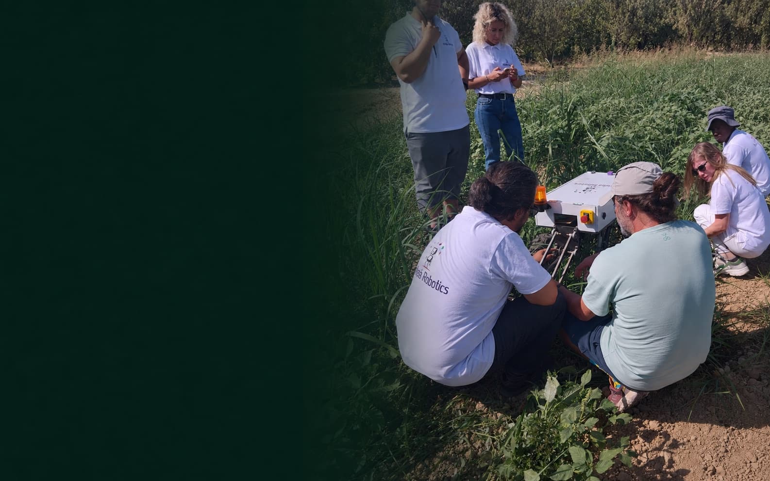 The Orbiba team and a farmer working together on the agricultural robot in the field