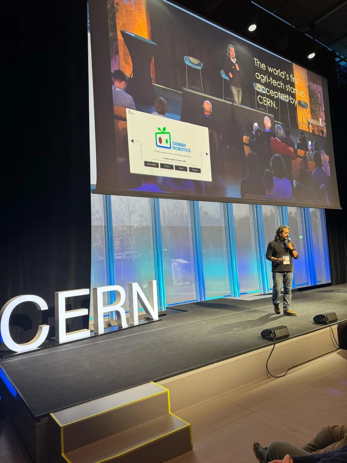 Orbiba Robotics founder Ilker Bektas presenting on stage at CERN
