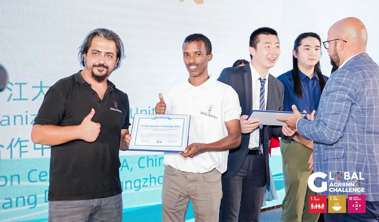 The Orbiba Robotics team receiving the FAO Global Agrinnovation Challenge 2024 Excellence Award